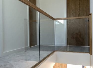Oak timber staircase with glass balustrade infill panels