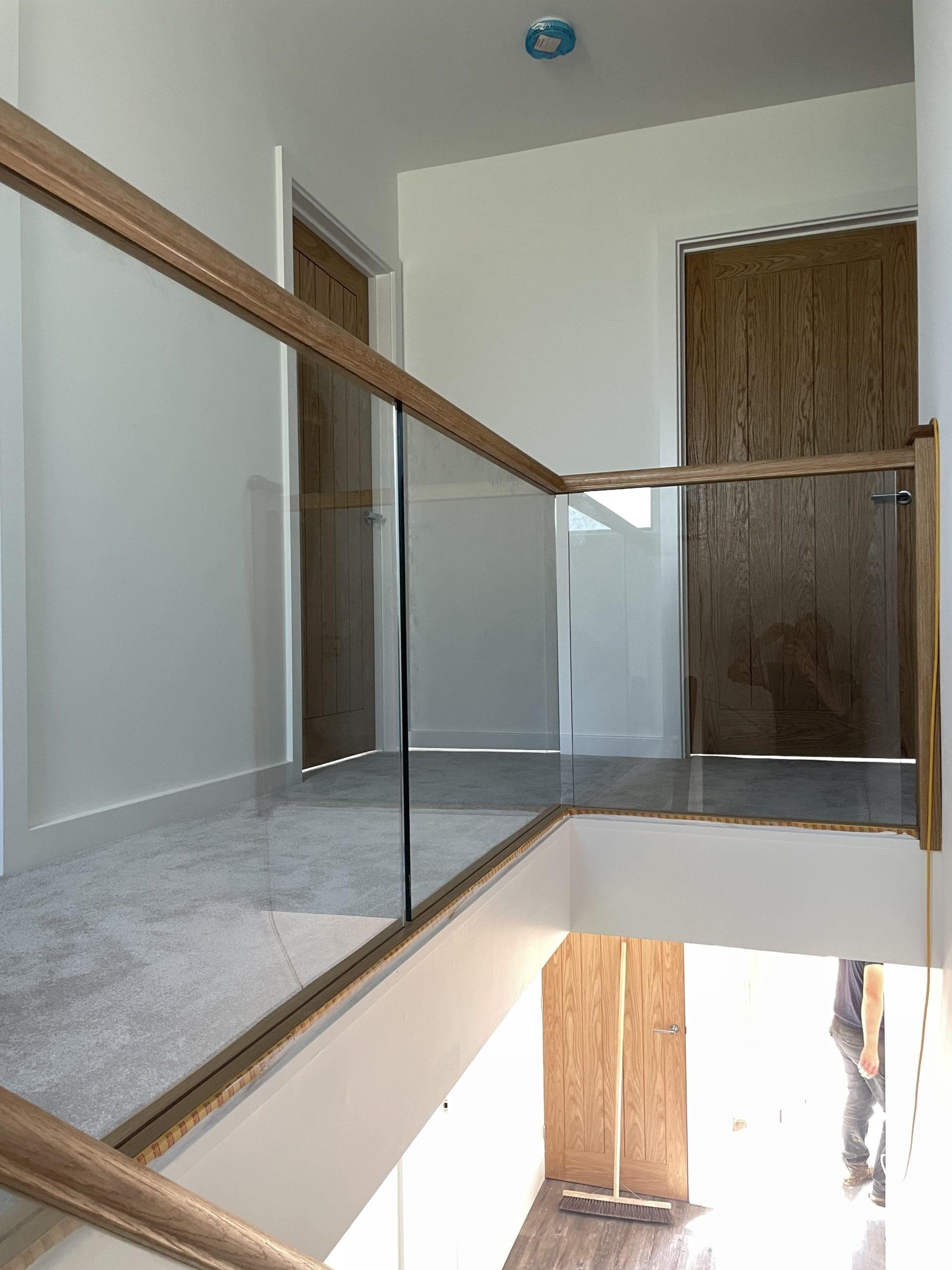 Oak timber staircase with glass balustrade infill panels