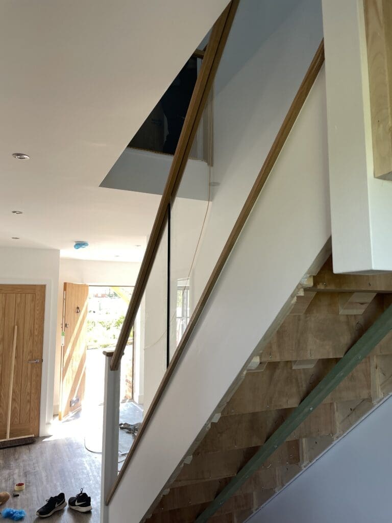 Oak timber staircase with glass balustrade infill panels