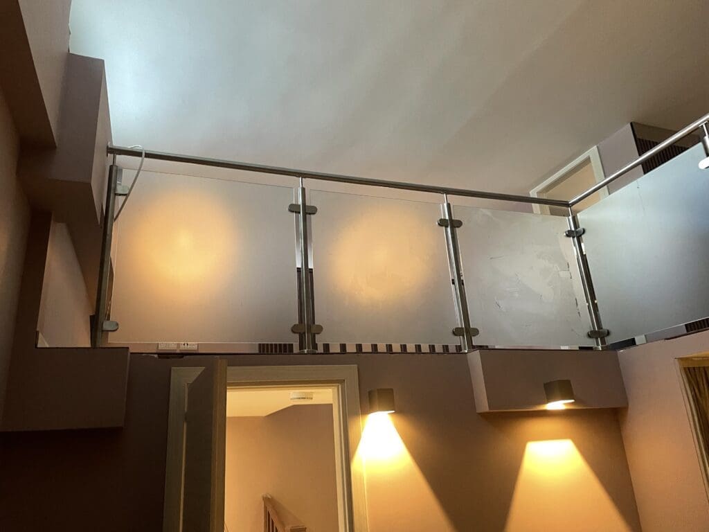 Internal glass balustrade with obscure glass panels
