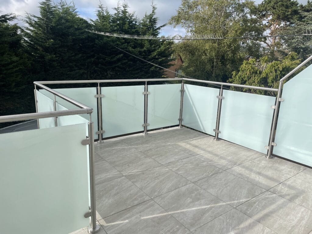 A glass balcony balustrade completed for a customer in Canvey Island, Essex. Using opaque 13.5mm toughened laminated glass panels