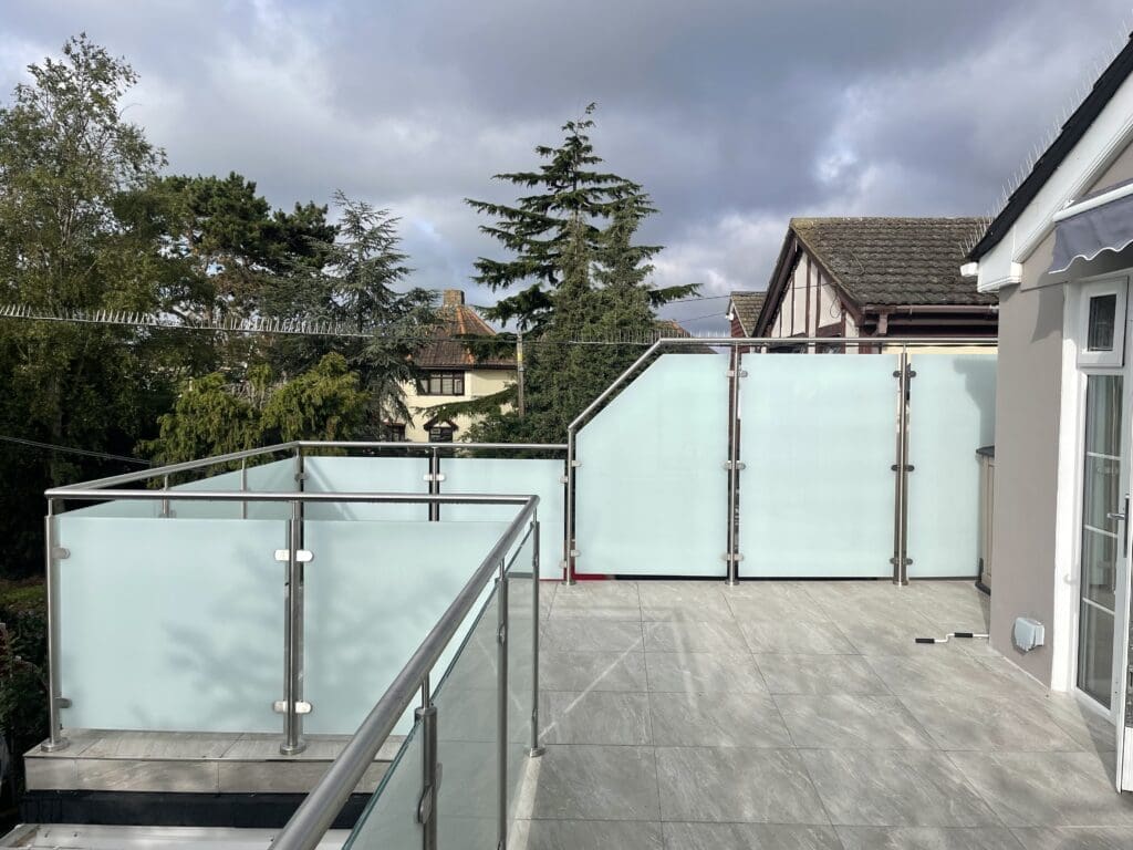 An opaque glass balcony balustrade installed for a customer in Canvey Island, Essex. Using 13.5mm toughened laminated glass panels