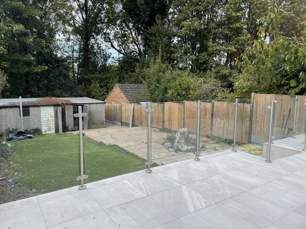 Free floating glass balustrade using 13.5mm toughened laminated glass panels and stainless steel post