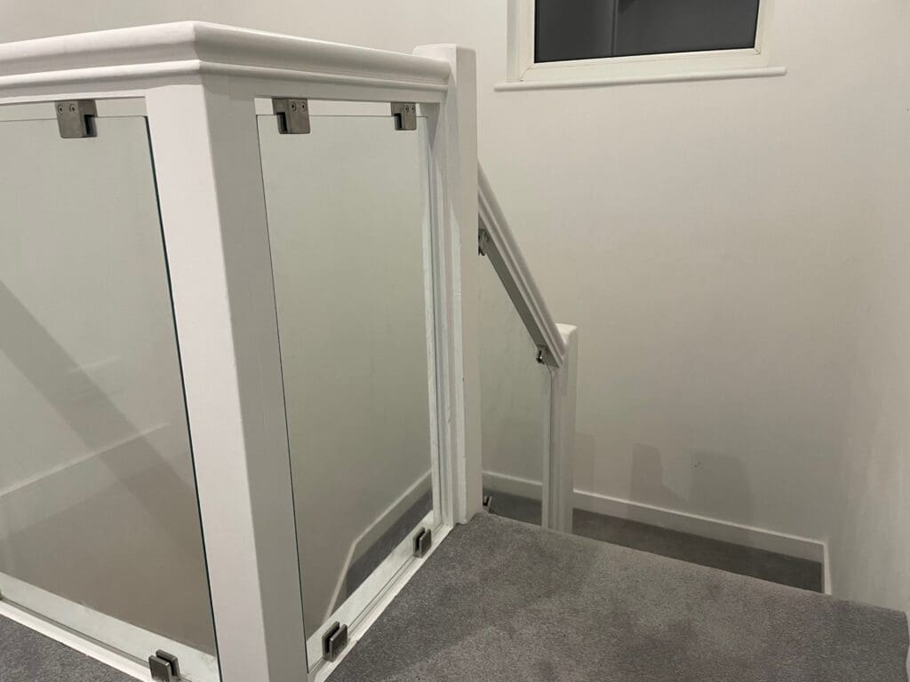 Glass Staircases 32 Stylish glass infill panels with stainless steel glass clamps