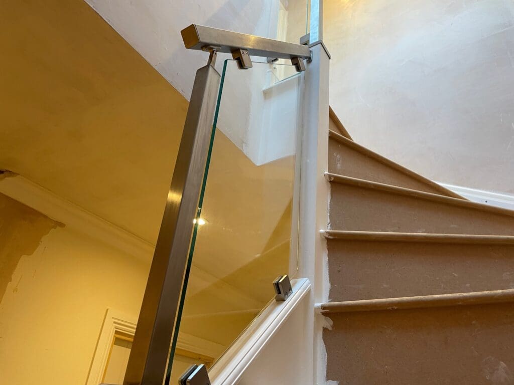 Stainless Steel handrail staircase renovation in Buckhurst Hill, Essex. Using 10mm clear toughened glass panels