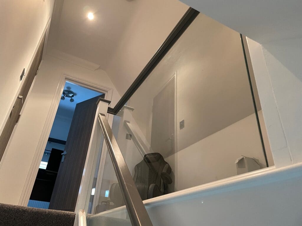 Homepage 2024 13 Staircase renovation in Chelmsford, Essex. Stripped out all the old timber and replaces with brand new slotted timber handrails and 10mm clear glass