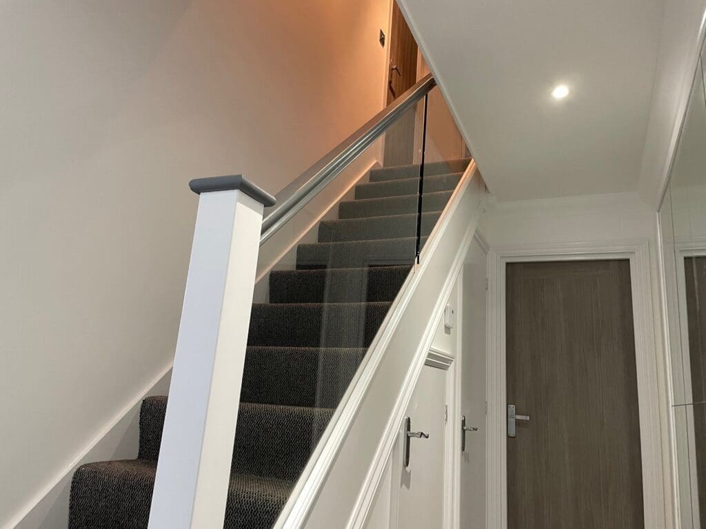 Staircase renovation in Chelmsford, Essex. Stripped out all the old timber and replaces with brand new slotted timber handrails and 10mm clear glass