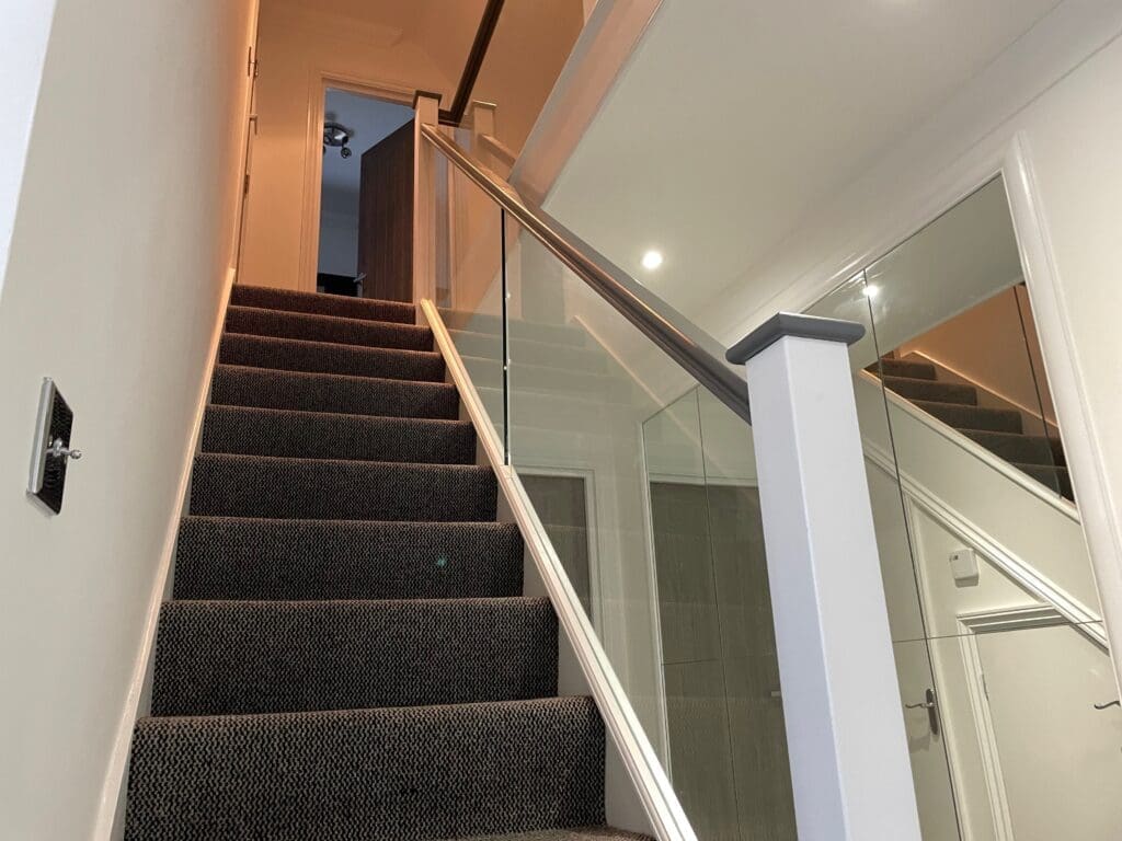 Staircase renovation in Chelmsford, Essex. Stripped out all the old timber and replaces with brand new slotted timber handrails and 10mm clear glass