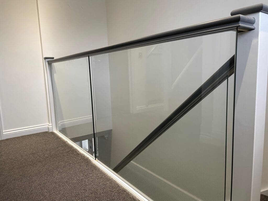 Brand new slotted timber handrail and base rail with 10mm clear toughened glass