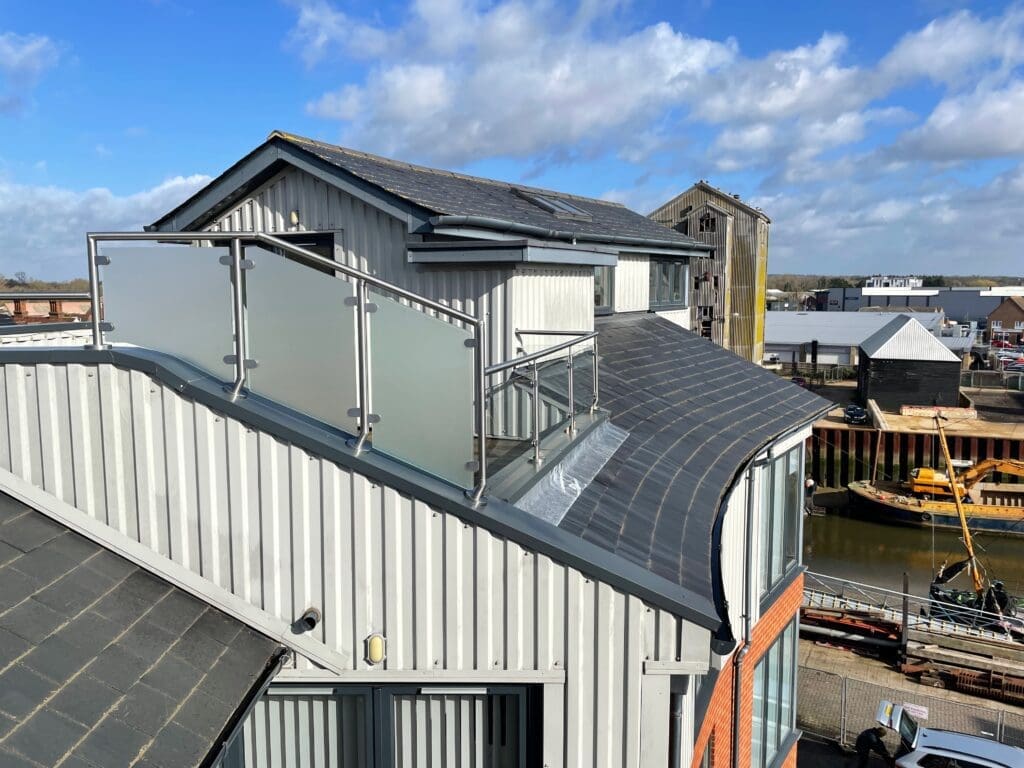 Balcony glass balustrade with a side privacy screen using a satin finish glass