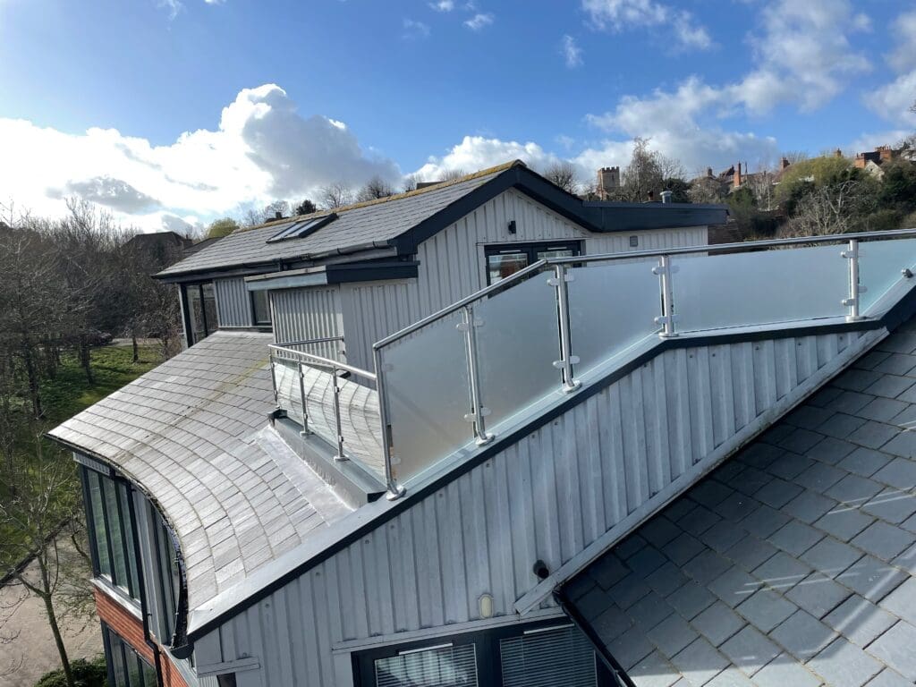 Balcony glass balustrade with a side privacy screen using a satin finish glass