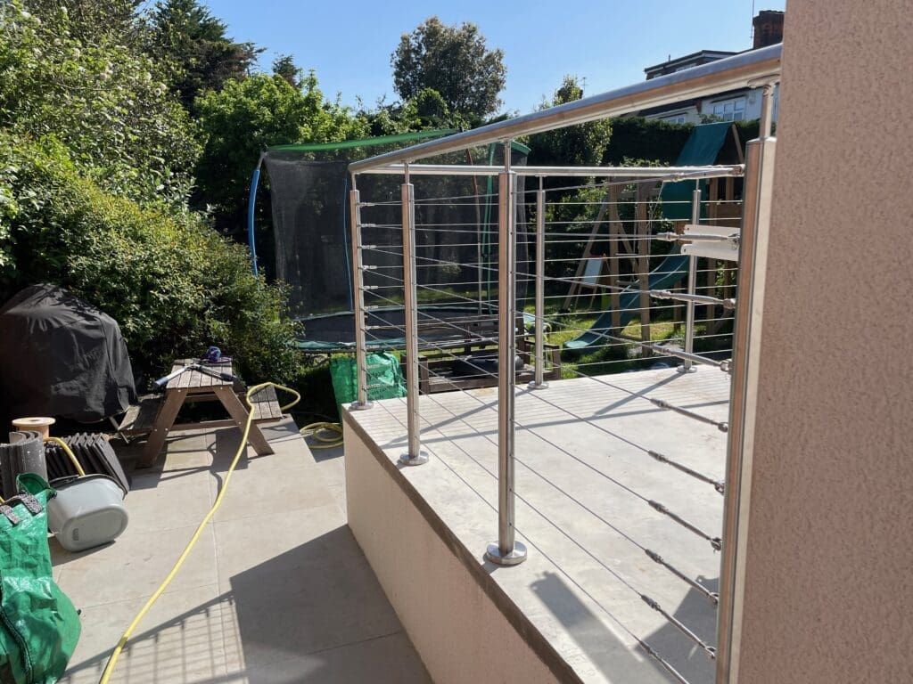 Stainless steel post and handrail system with a wire balustrade